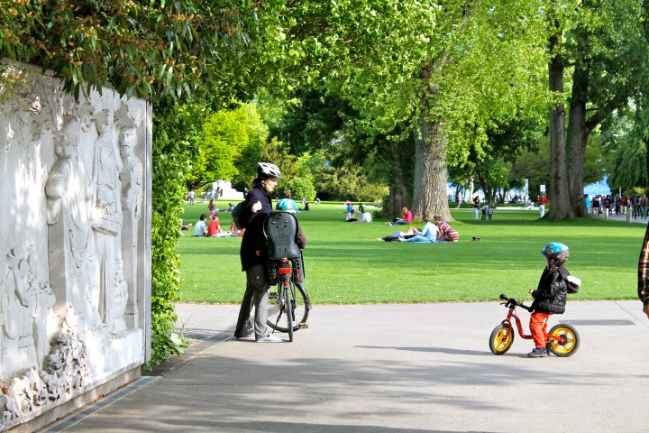 The young boy on his fake bike, with his mom & sister on the real bike!